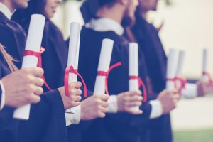 a group of graduated students holding own academic recognition