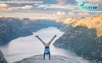 Man performing a handstand on a mountain peak against a breathtaking backdrop, symbolizing the triumph over challenging feats such as validating a foreign PhD in Italy