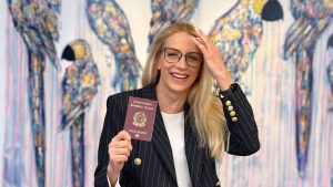 Smiling woman holding a passport after learning about the 2025 Italian citizenship reform (Law 74/2025) on citizenship by descent