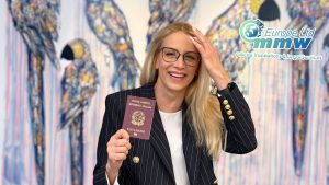 Smiling woman holding a passport after learning about the 2025 Italian citizenship reform (Law 74/2025) on citizenship by descent